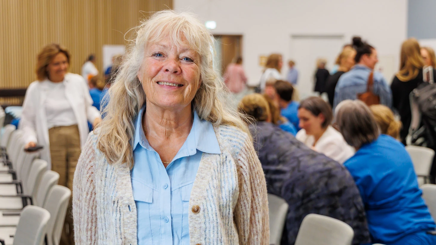 En deltager ved TRIO-workshoppen om belastningspsykologi står foran de øvrige deltagere i salen.